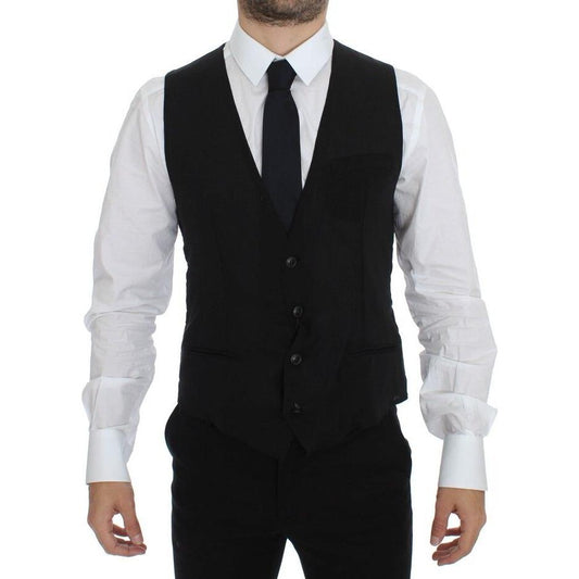Man wearing Dolce & Gabbana black wool formal dress vest, showcasing a stylish formal look with a white shirt and black tie.