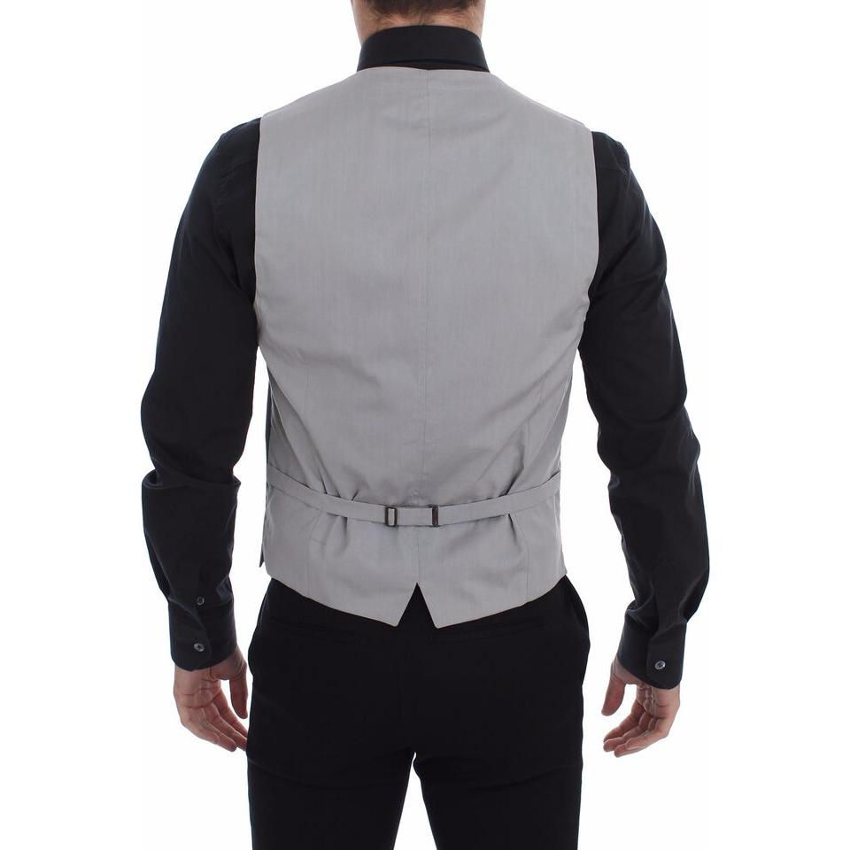 Back view of a man wearing a Dolce & Gabbana gray cotton slim fit dress vest with adjustable strap.