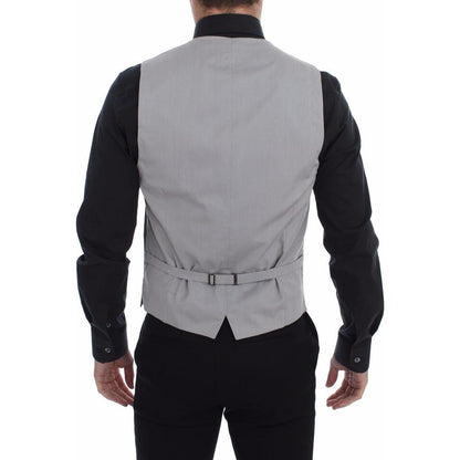 Back view of a man wearing a Dolce & Gabbana gray cotton slim fit dress vest with adjustable strap.