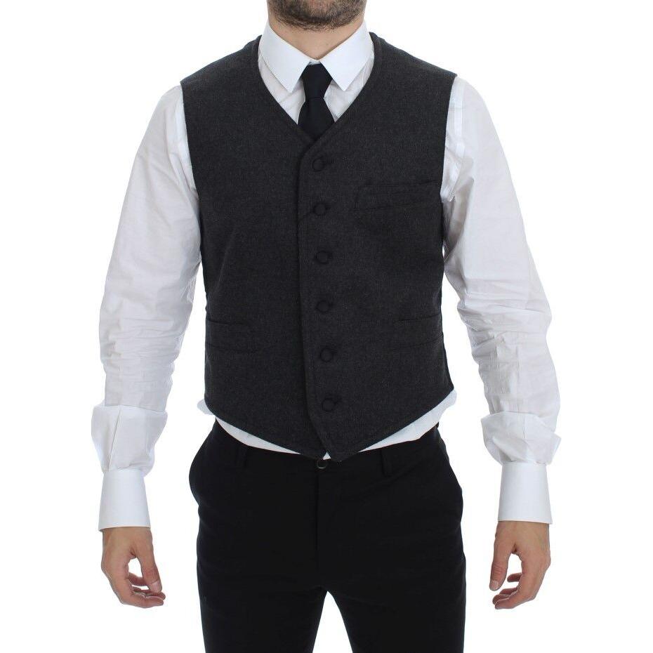 Dolce Gabbana gray wool blend vest shown on model, featuring a single breasted design with adjustable back waist strap.