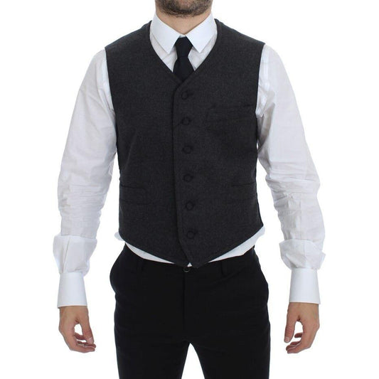 Dolce Gabbana gray wool blend vest shown on model, featuring a single breasted design with adjustable back waist strap.